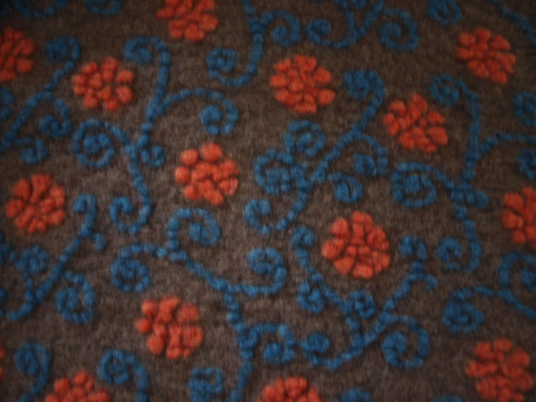 Musterwalk Winter 2025/26 Neu  Blumen auf orange petrol auf taupe Walkloden Italien